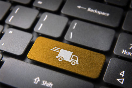 Transport delivery key with truck icon on laptop keyboard. Included clipping path, so you can easily edit it.